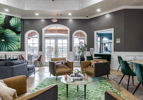 a living room with couches and chairs and a table